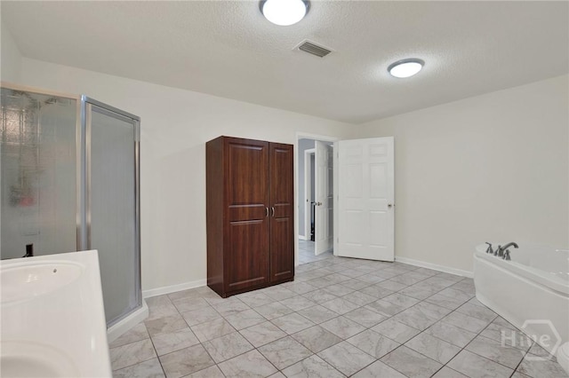 46 River Oaks Rd, Savannah, GA 31410 - bathroom featuring a textured ceiling, a stall shower, a garden tub, and baseboards