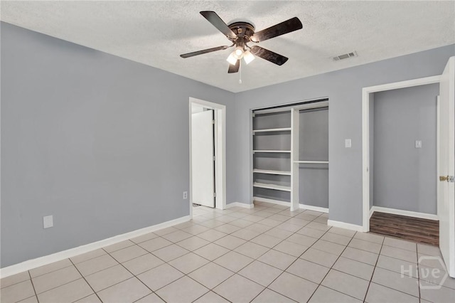 46 River Oaks Rd, Savannah, GA 31410 - unfurnished bedroom with a textured ceiling, light tile patterned floors, a closet, baseboards, and ceiling fan