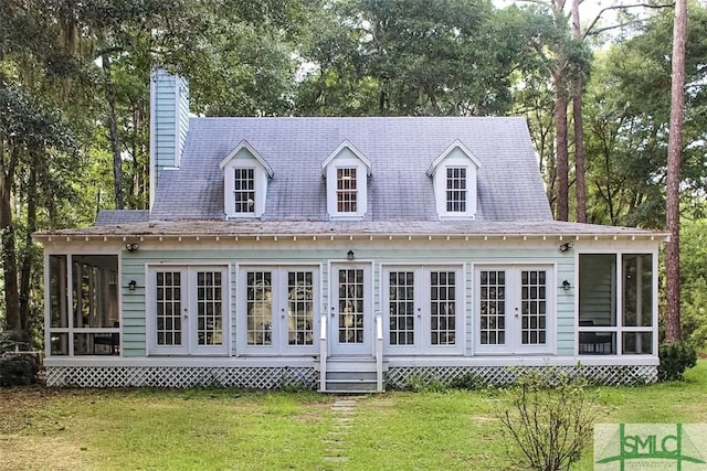 back of house featuring a yard and a sunroom