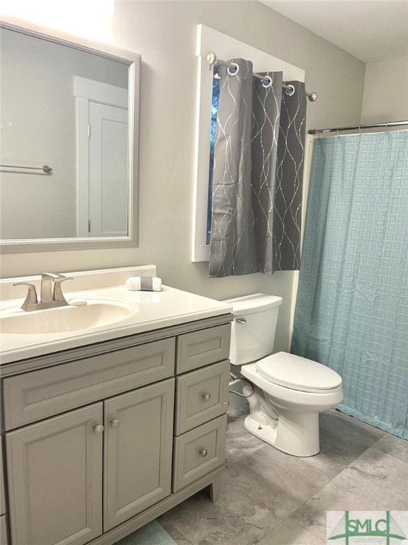 bathroom featuring vanity, toilet, and a shower with shower curtain