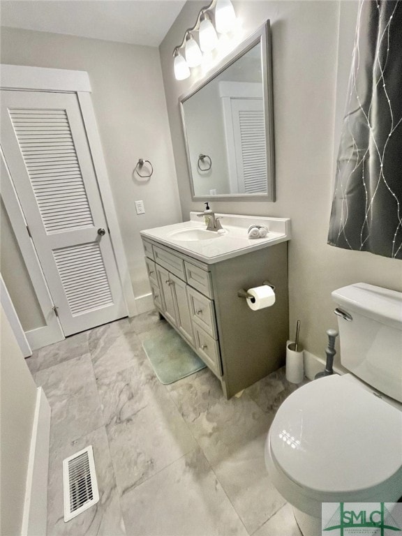 bathroom with vanity and toilet