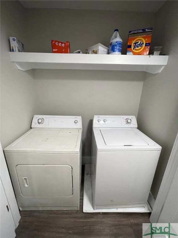 washroom featuring washing machine and dryer and dark hardwood / wood-style flooring