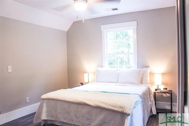 bedroom with lofted ceiling, ceiling fan, and dark wood-type flooring