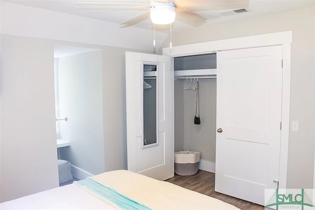 bedroom with dark hardwood / wood-style floors and ceiling fan