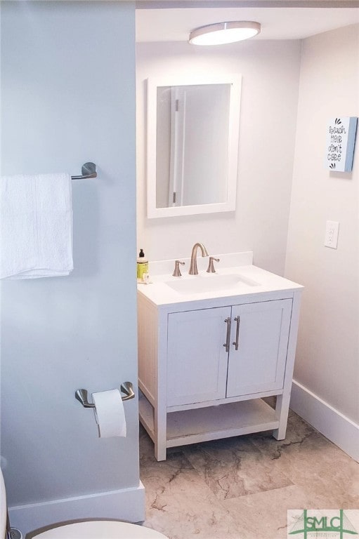 bathroom featuring vanity and toilet