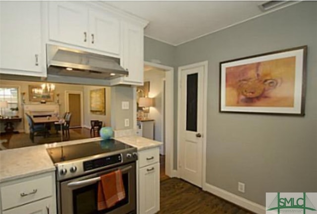 kitchen featuring white cabinets, high end stove, and dark hardwood / wood-style floors