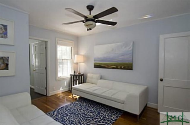 living room featuring ceiling fan and dark hardwood / wood-style flooring