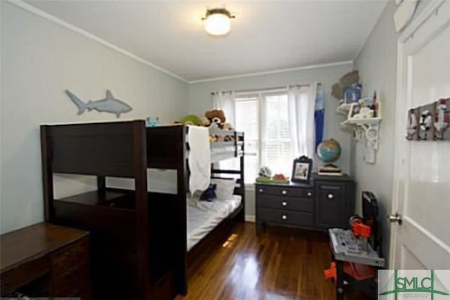 bedroom featuring crown molding and dark hardwood / wood-style flooring