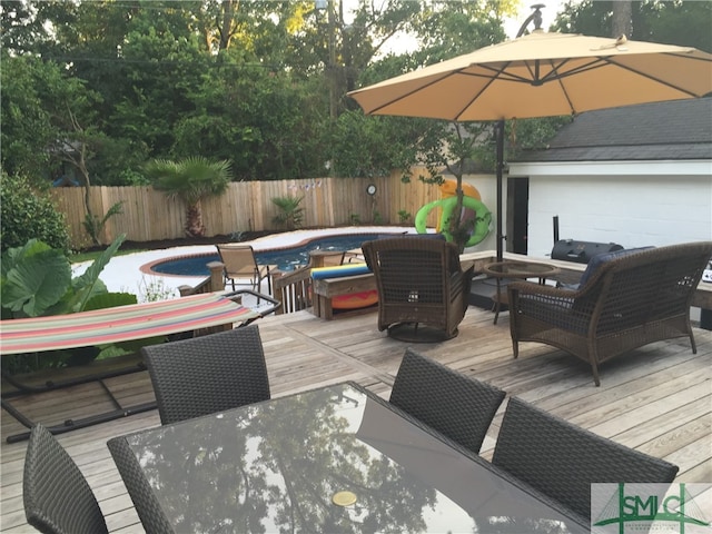 wooden deck featuring a swimming pool with hot tub and an outdoor living space