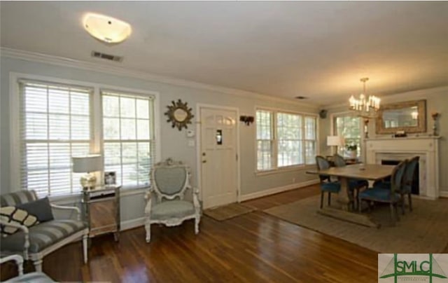 dining area featuring crown molding, dark wood-type flooring, and a chandelier