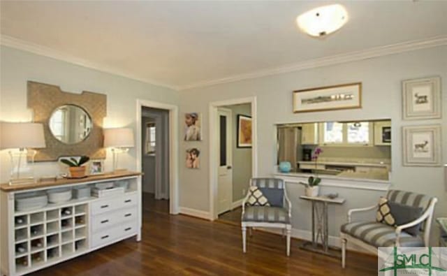 sitting room featuring dark hardwood / wood-style floors and ornamental molding