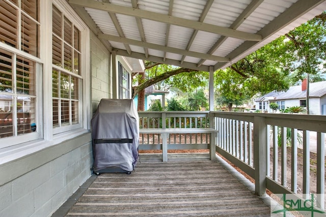 wooden deck featuring a grill