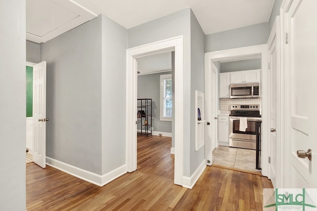 corridor with light hardwood / wood-style flooring