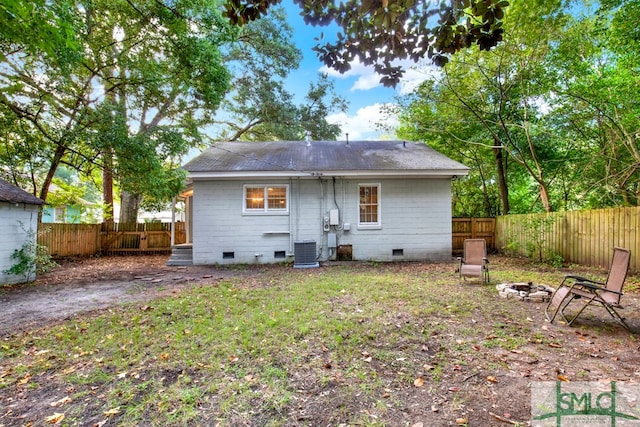 back of property featuring cooling unit and a fire pit