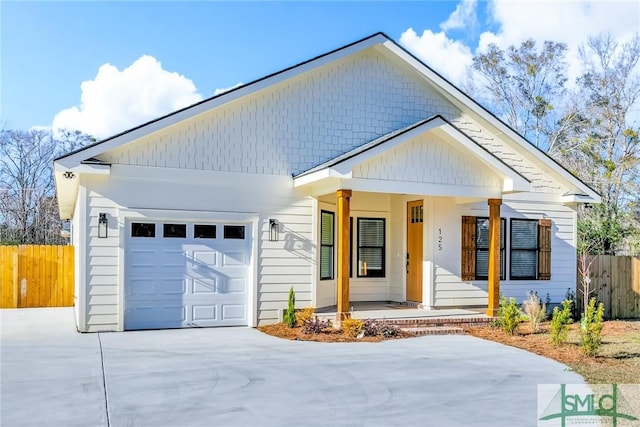 view of front facade featuring a garage and covered porch