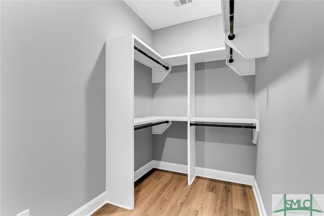 spacious closet featuring light wood-type flooring