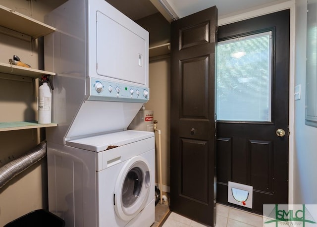 159 E 1st St, Midway, GA 31320 - laundry area with stacked washer / dryer and light tile patterned flooring
