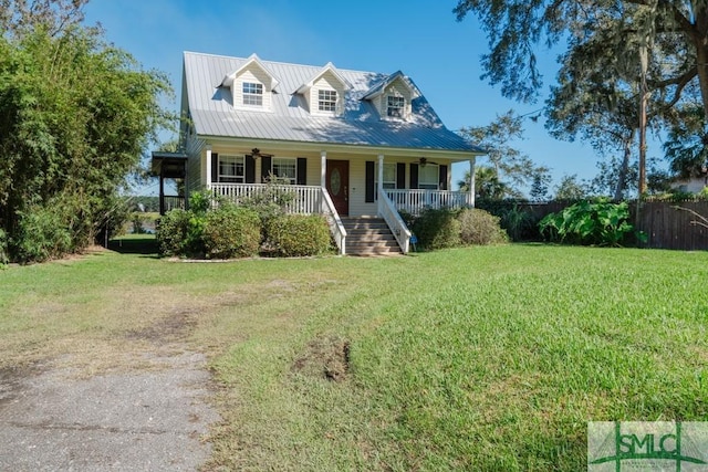 159 E 1st St, Midway, GA 31320 - new england style home featuring a porch, a ceiling fan, stairway, and a metal roof