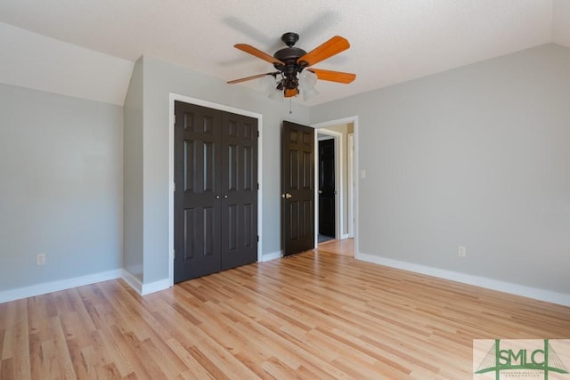 159 E 1st St, Midway, GA 31320 - unfurnished bedroom with light wood-style flooring, a closet, ceiling fan, and lofted ceiling
