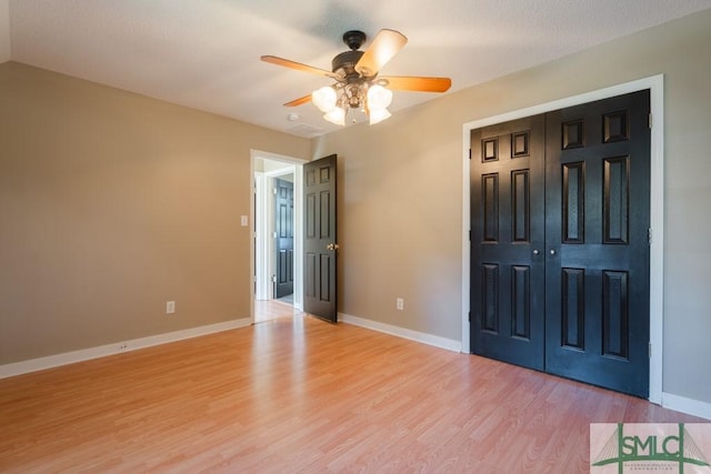 159 E 1st St, Midway, GA 31320 - unfurnished bedroom featuring light wood-style floors, a closet, and a ceiling fan
