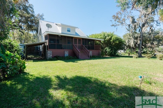 159 E 1st St, Midway, GA 31320 - back of house with a sunroom, a lawn, stairs, and an attached carport