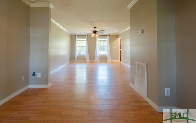 159 E 1st St, Midway, GA 31320 - empty room featuring crown molding, ceiling fan, light wood-style floors, and a textured ceiling