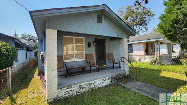 rear view of house featuring a lawn