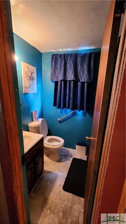 bathroom featuring vanity and toilet