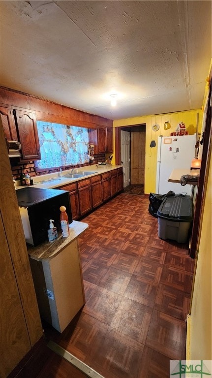 kitchen featuring dark parquet floors and white refrigerator