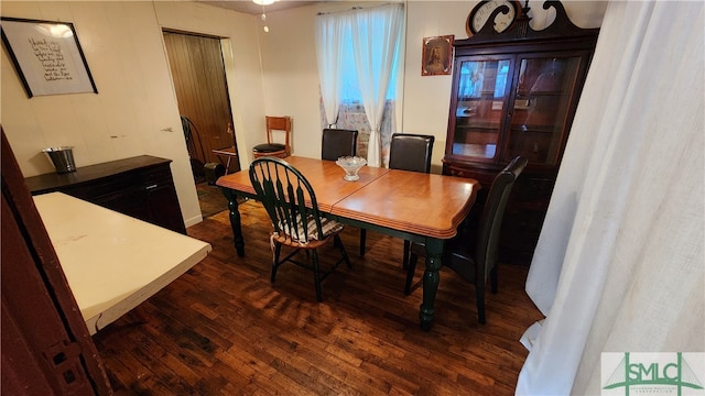 dining area with dark hardwood / wood-style flooring