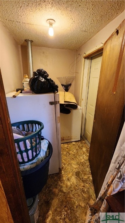 interior space with washer / clothes dryer and a textured ceiling