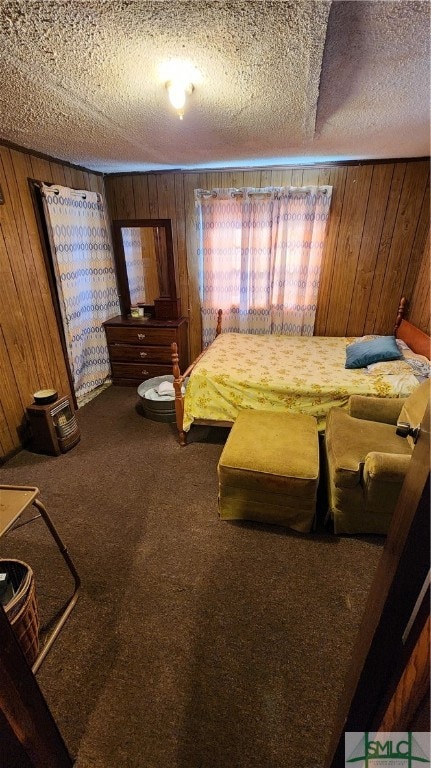 unfurnished bedroom with carpet floors, a textured ceiling, and wood walls