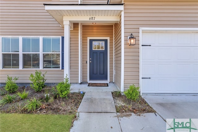 view of exterior entry with a garage