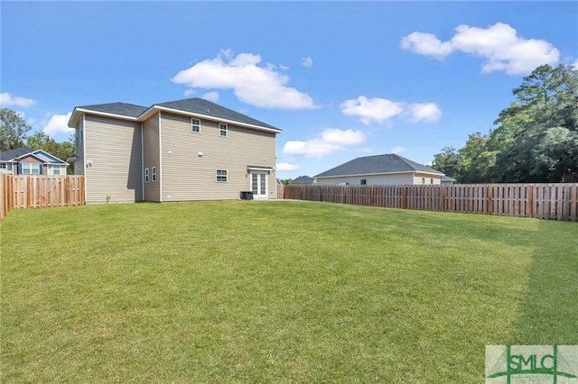 rear view of property with a lawn