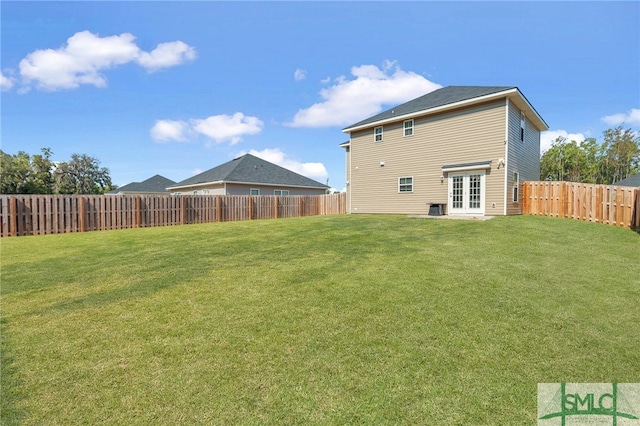 back of house with french doors and a lawn