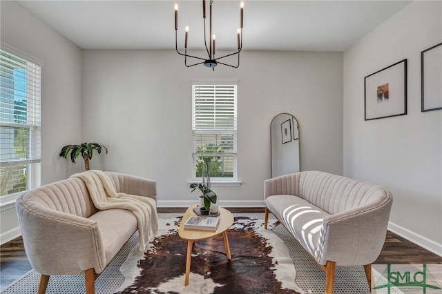 living area featuring plenty of natural light, a chandelier, and hardwood / wood-style flooring