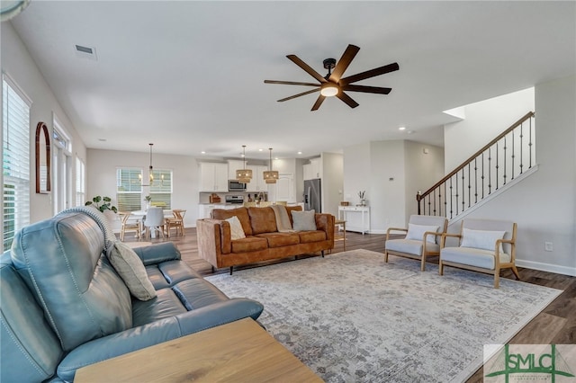 living room featuring hardwood / wood-style flooring and ceiling fan