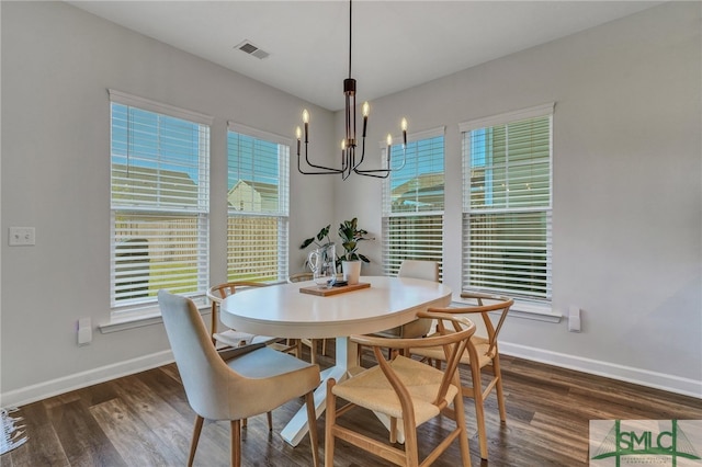 dining room featuring a chandelier and dark hardwood / wood-style flooring