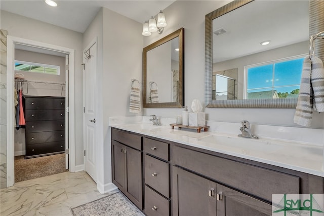 bathroom featuring walk in shower and vanity