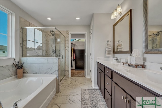 bathroom featuring vanity, shower with separate bathtub, and a healthy amount of sunlight