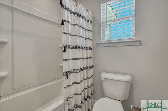 bathroom with toilet and shower / bathtub combination with curtain