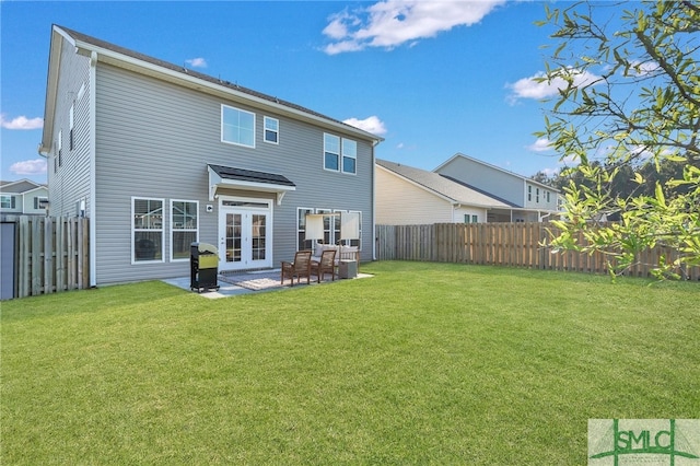 back of house with french doors, a lawn, and a patio area