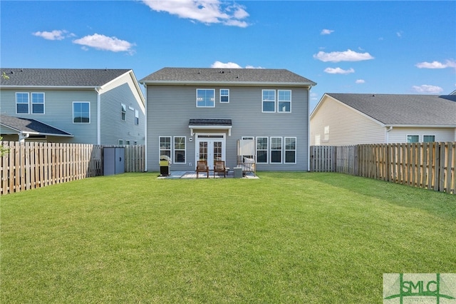 back of property with a yard, french doors, and a patio area