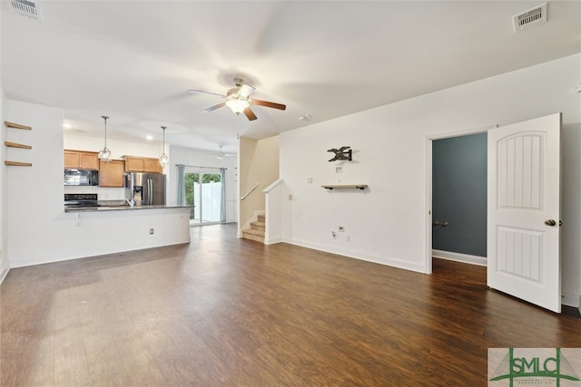 unfurnished living room with ceiling fan and dark hardwood / wood-style floors