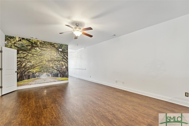 empty room with dark wood-type flooring and ceiling fan