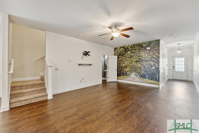 unfurnished living room featuring dark wood-type flooring and ceiling fan