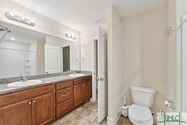 bathroom featuring walk in shower, vanity, and toilet