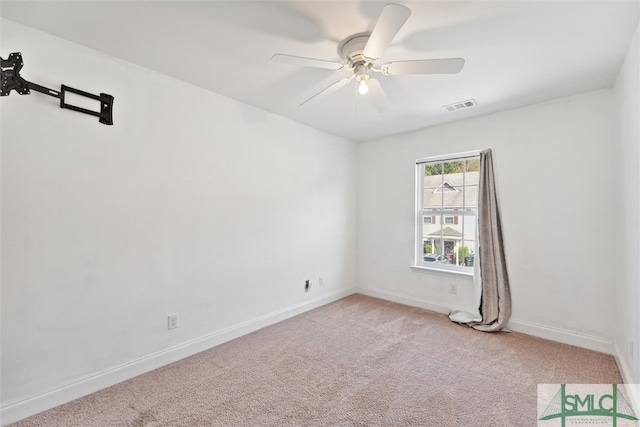 carpeted spare room with ceiling fan