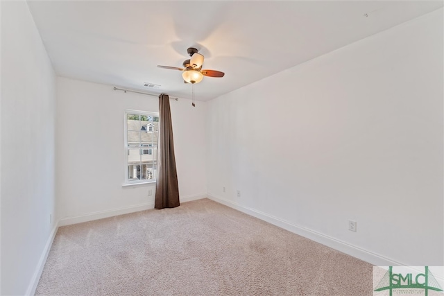 carpeted spare room with ceiling fan