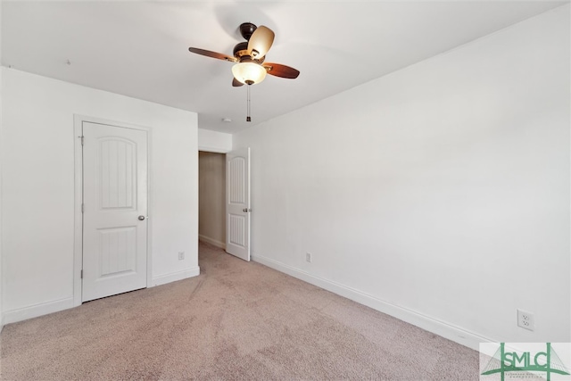 unfurnished bedroom featuring light carpet and ceiling fan